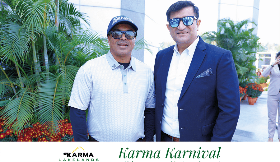 Two individuals standing with the sunglasses on in the bright day light.