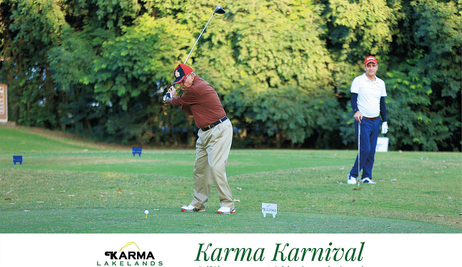 Picture of a two people playing golf at the karma karnival tournament