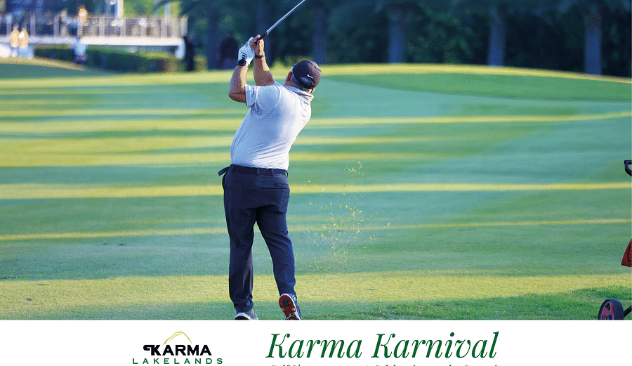 Picture of a man  swinging the club in the bright day light.