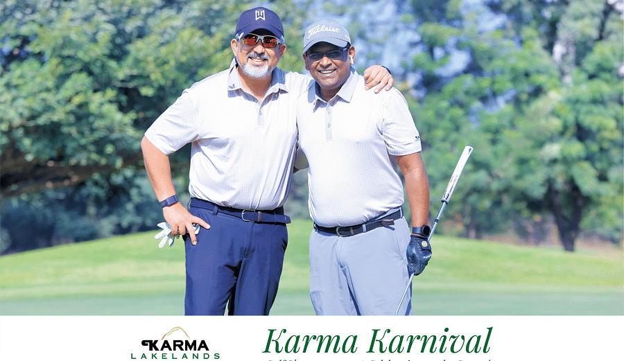 Two players posing for a picture at the golf tournament