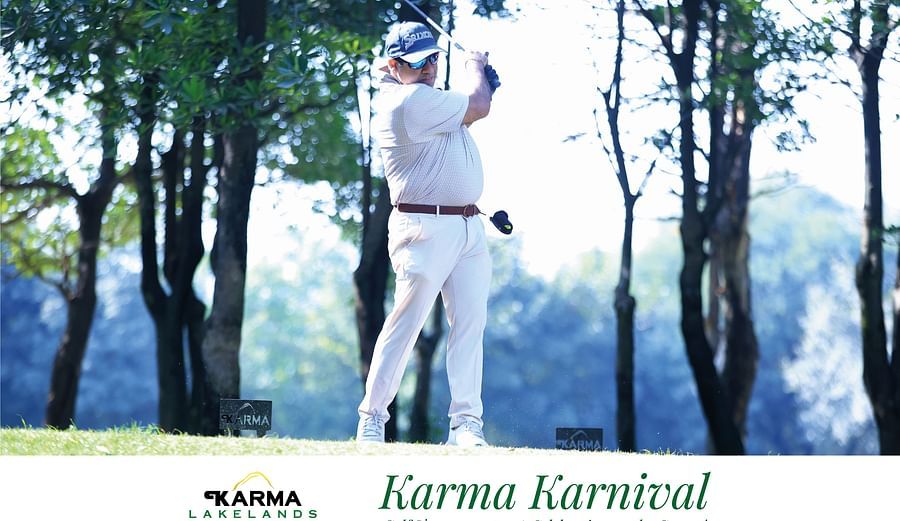 Picture of a man  swinging the club in the bright day light.