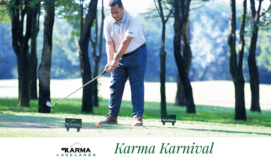 Picture of a man  swinging the club in the bright day light.