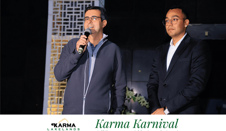 Picture featuring two people, one speaking and another standing next to him. 
