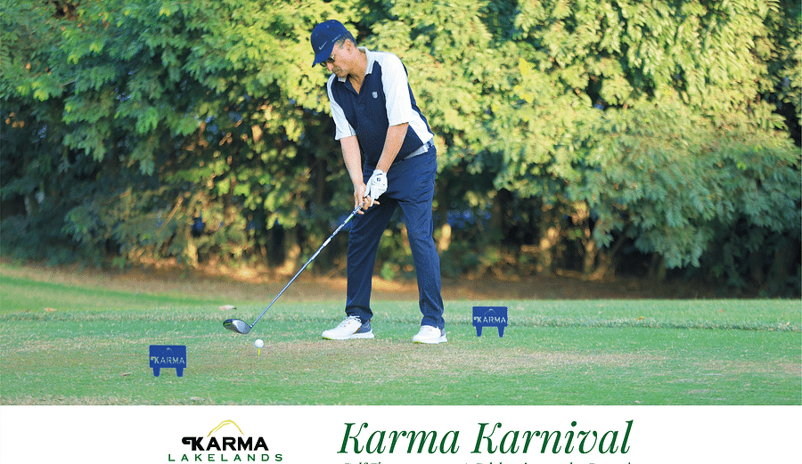 Picture of a person playing golf, holding the club to hit the ball.