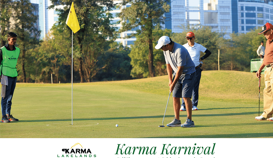 Picture featuring a few people playong golf and a person putting.