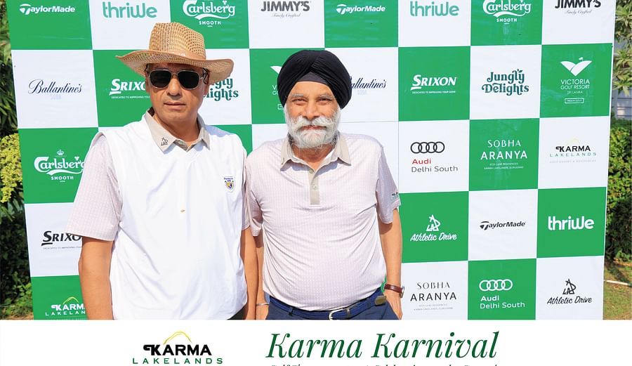 Picture of two individuals posing for the picture with the background of karma lakelands backdrop.