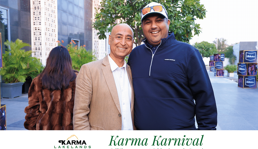 Picture of two individuals smiling and posing at the bright day light