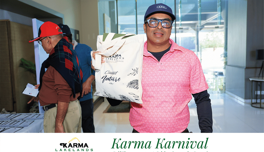 Picture of a person posing with the event goodies.
