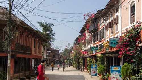 A person walking on a street in Bandipur.