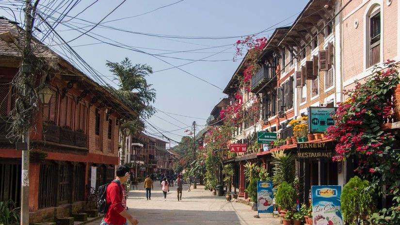 A person walking on a street in Bandipur.