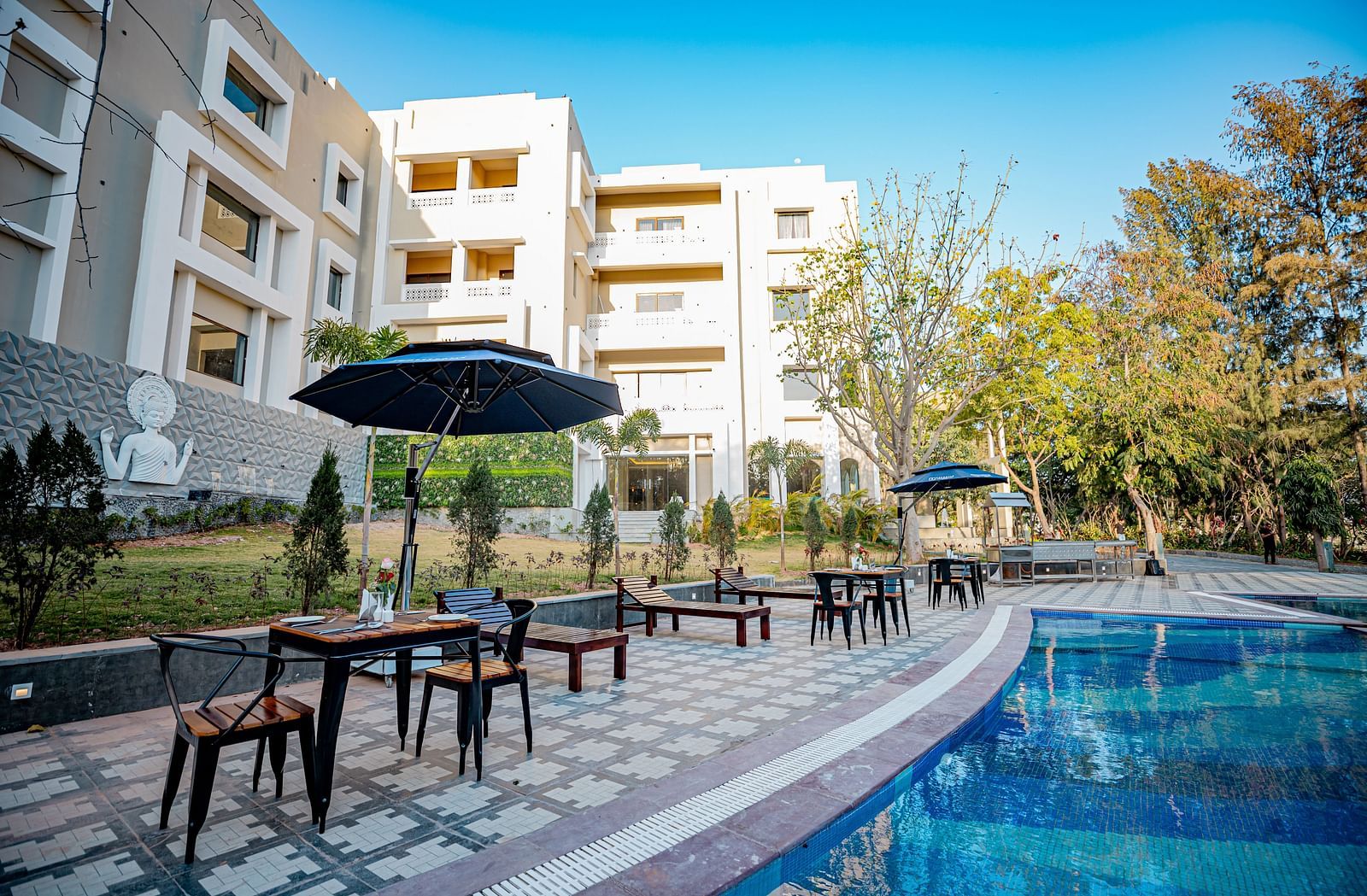 A view of the dining setting placed by the pool at Essentia Luxury Resort & Spa, Udaipur.