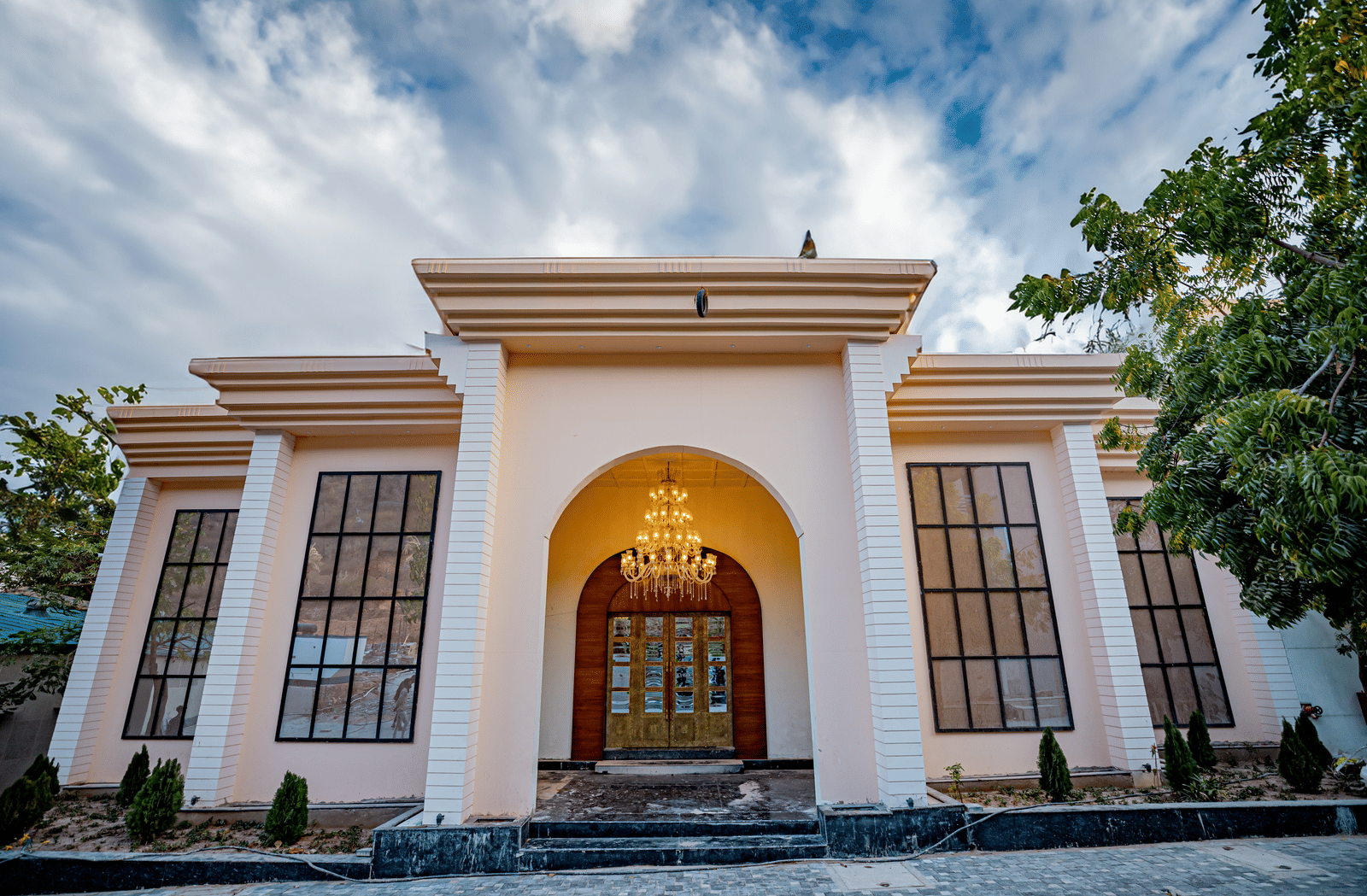 Entrance of Essentia Luxury Resort & Spa, Udaipur featuring a chandelier hanging from the ceiling