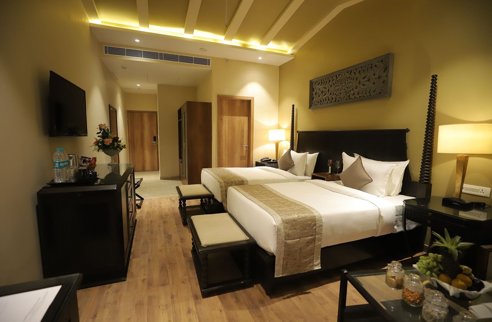 Studio Quad Room with double beds placed in front of TV at Essentia Luxury Resort & Spa, Udaipur.