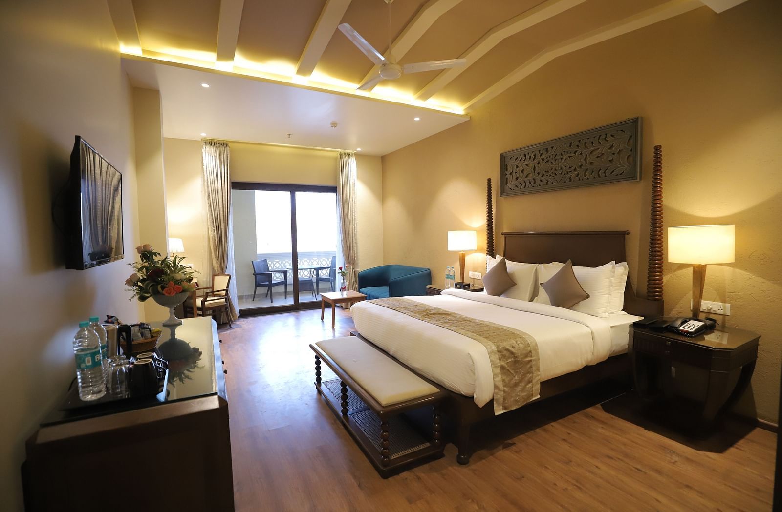 Premium room with a king size bed placed in front of a TV at Essentia Luxury Resort & Spa, Udaipur.