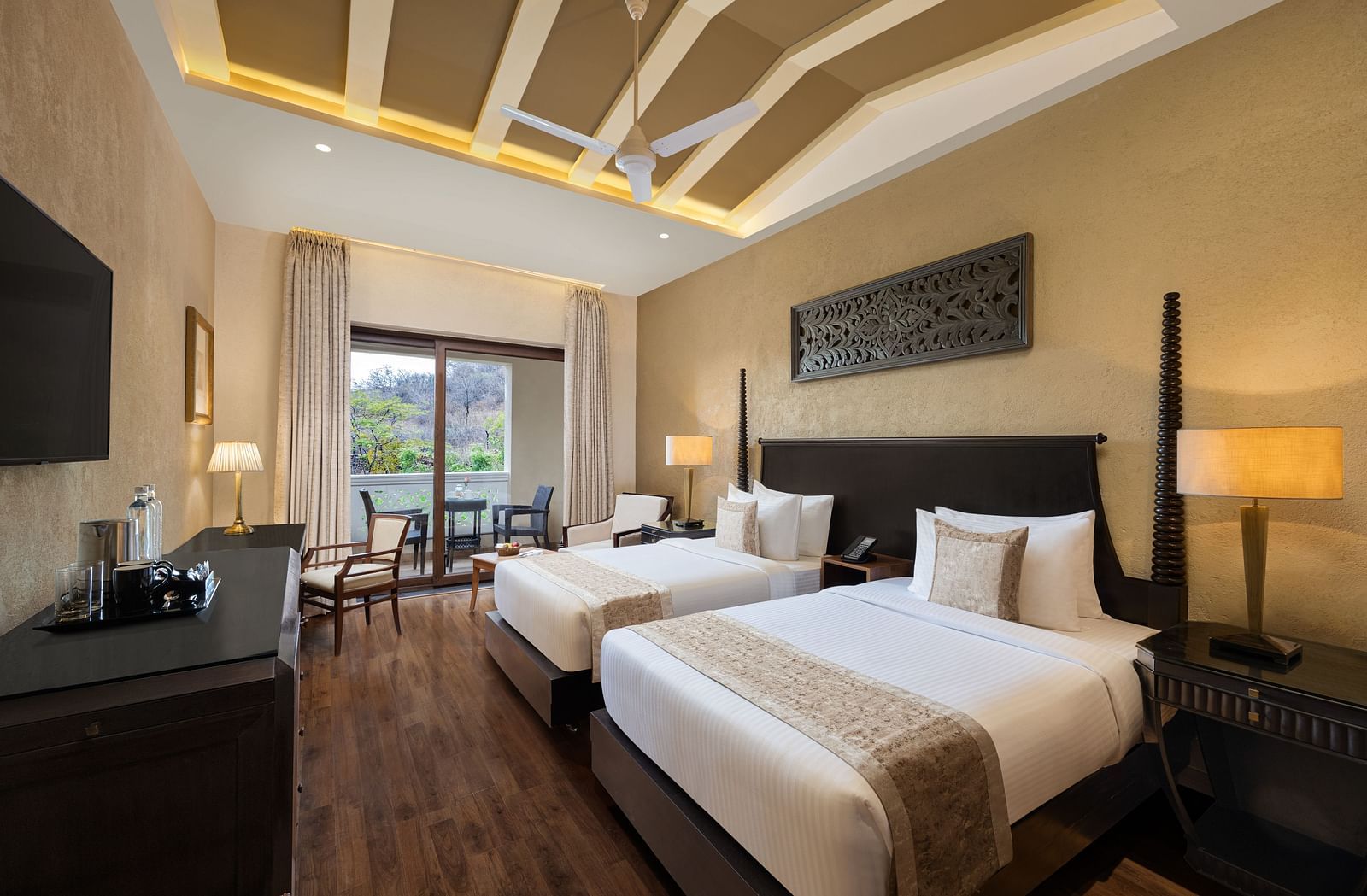 Premium room with a two single size beds placed in front of a TV at Essentia Luxury Resort & Spa, Udaipur.