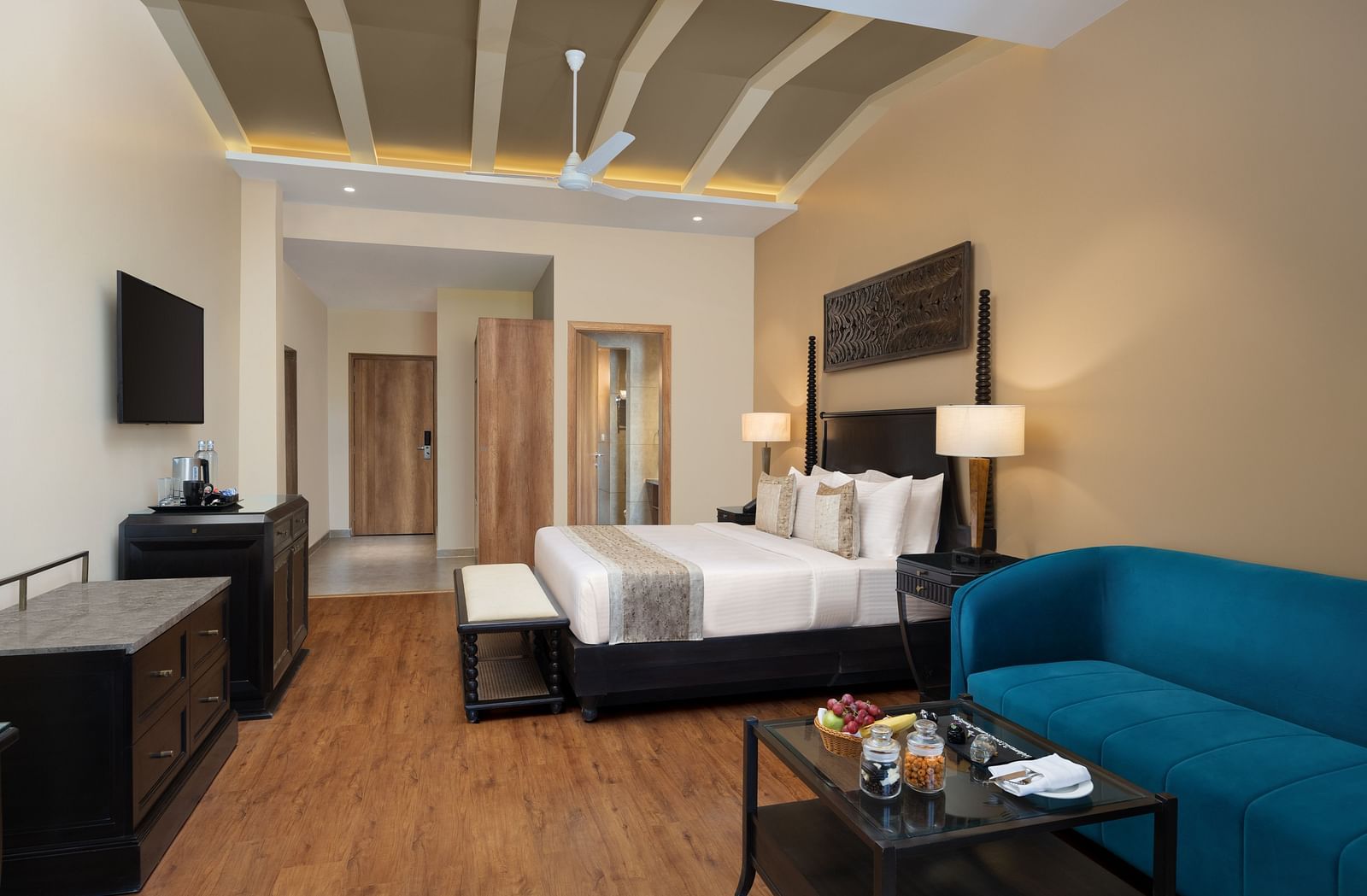 Premium room with a king size bed placed in front of a TV at Essentia Luxury Resort & Spa, Udaipur.