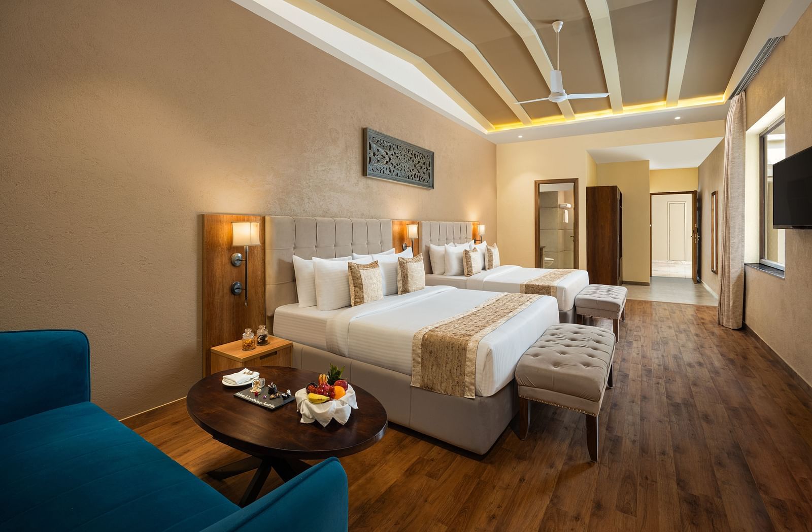 Studio Quad Room with double beds placed in front of TV at Essentia Luxury Resort & Spa, Udaipur.