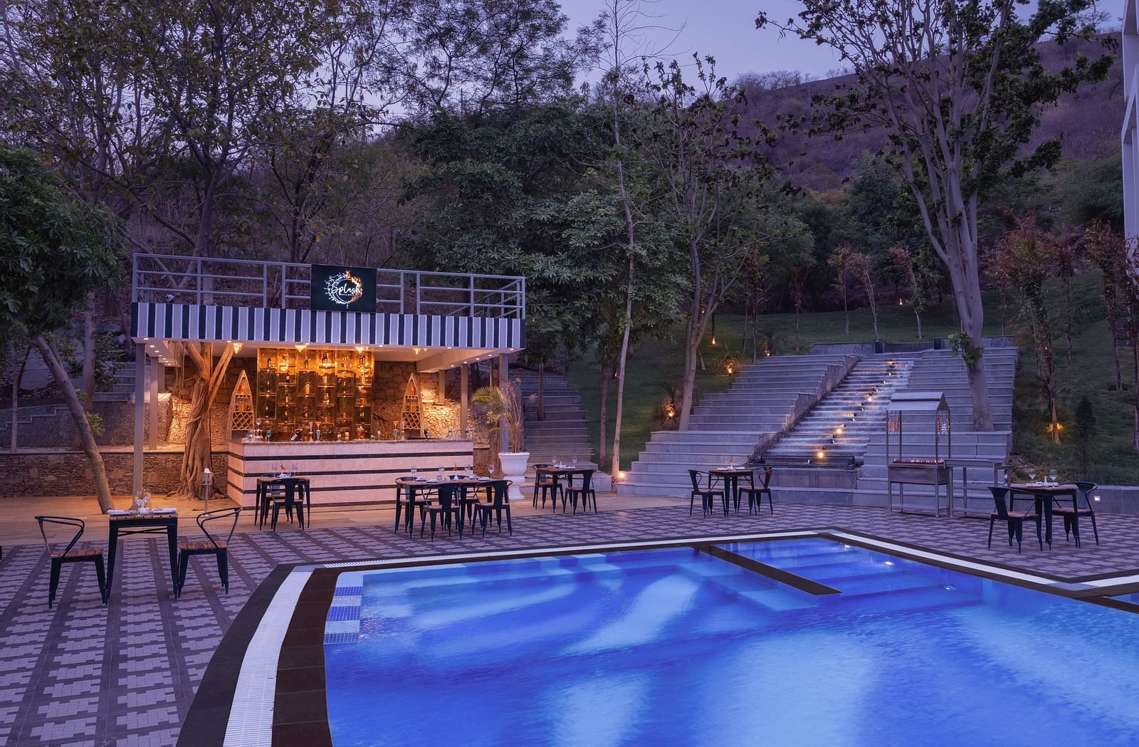 A swimming pool view at evening at Essentia Luxury Resort & Spa, Udaipur.