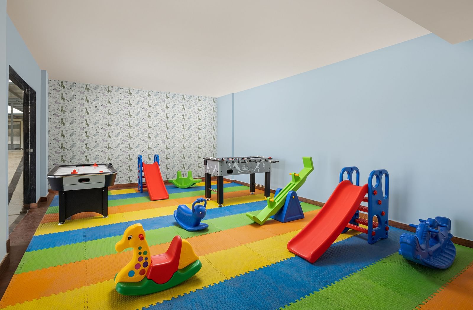 A playroom with toys placed on colourful mats at Essentia Luxury Resort & Spa, Udaipur.