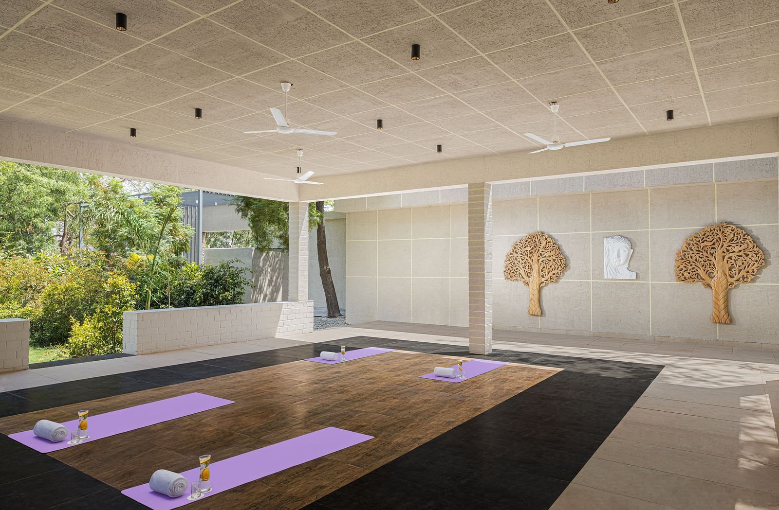 An elegant placement of yoga mats and lemonade in a room at Essentia Luxury Resort & Spa, Udaipur.