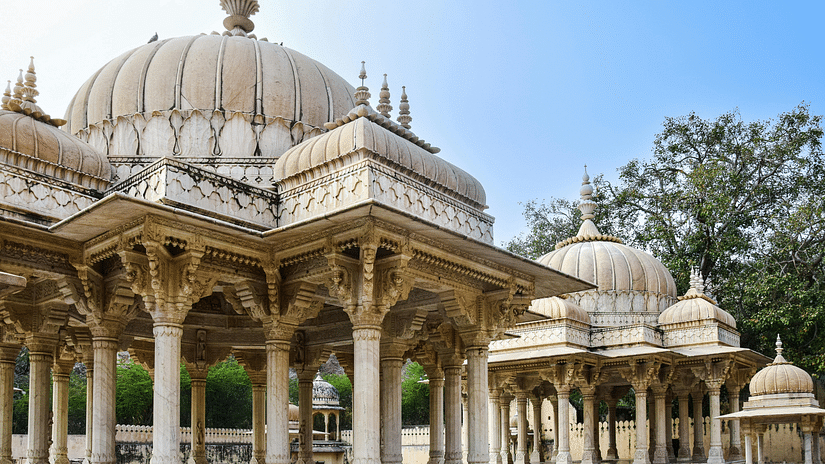View of a traditional building with domed roofs, columns, and detailed stonework.