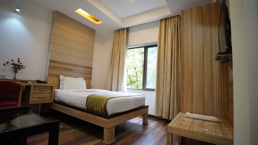 an image of a standard bedroom with a fan hanging from the ceiling at  City Centre Residency, Bangalore