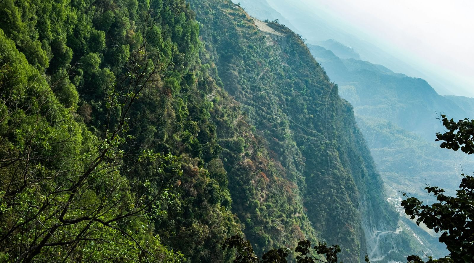 a scenic view of a mountain with a valley in the distance