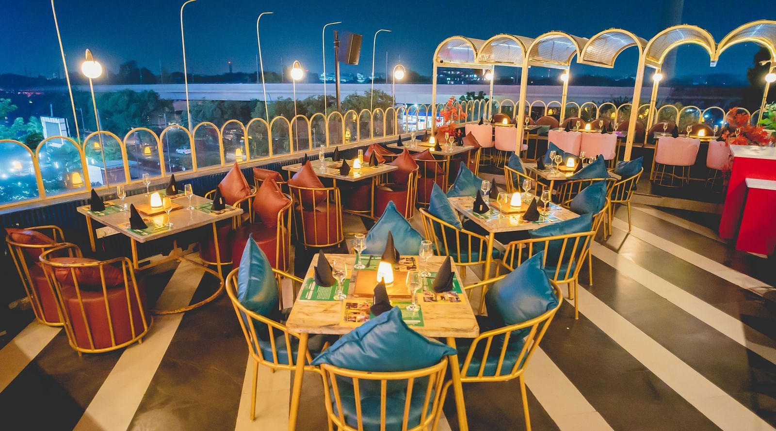 An image of a seating area on the rooftop of Themis Barbecue House with tables and chairs