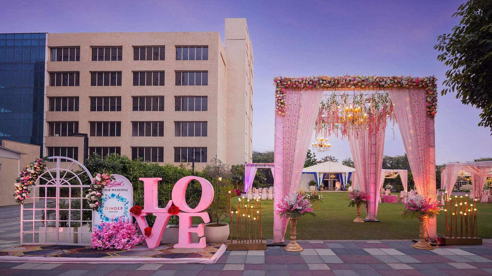 an entrance to an event space with a canopy as the entry and Love written with large letters - The Hideaway Banquets & Lawns, Greater Noida