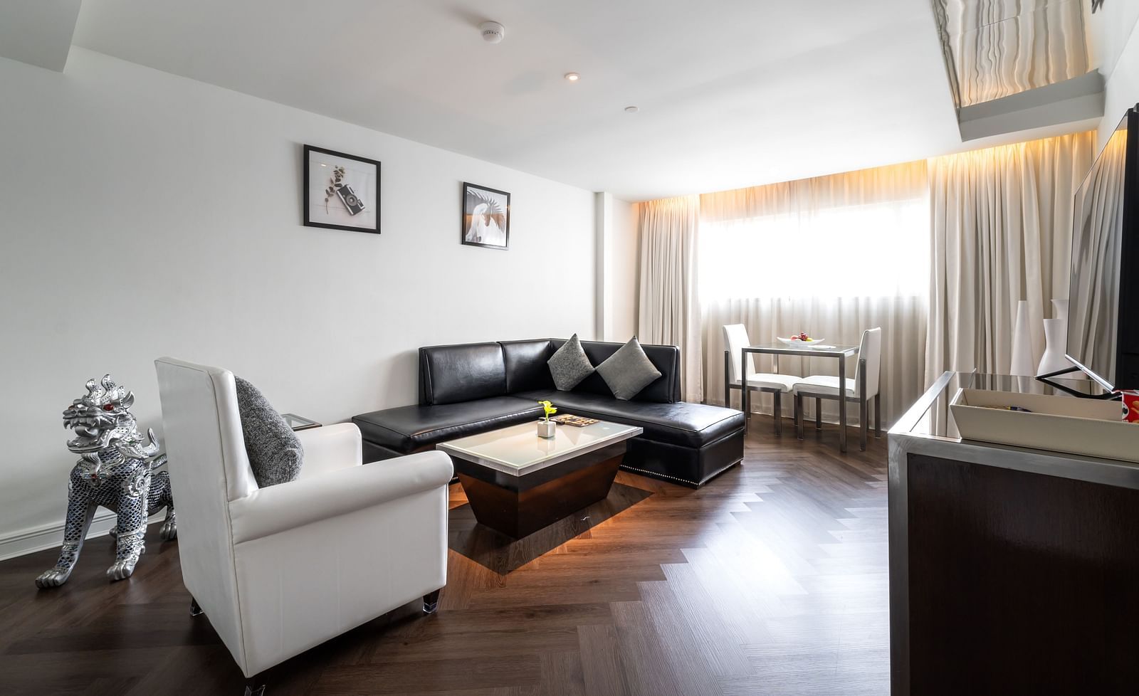 An overview of the living room with sofas and table in view - Night Hotel Bangkok.