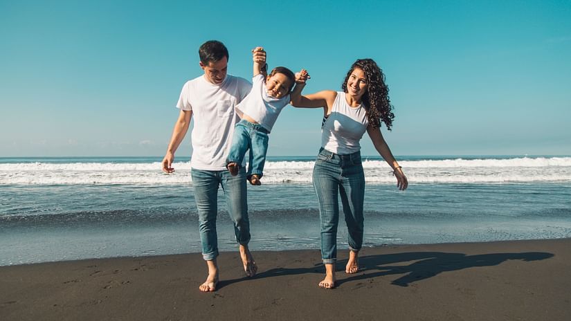 happy-young-family-having-fun-with-baby-sunny-beach 1