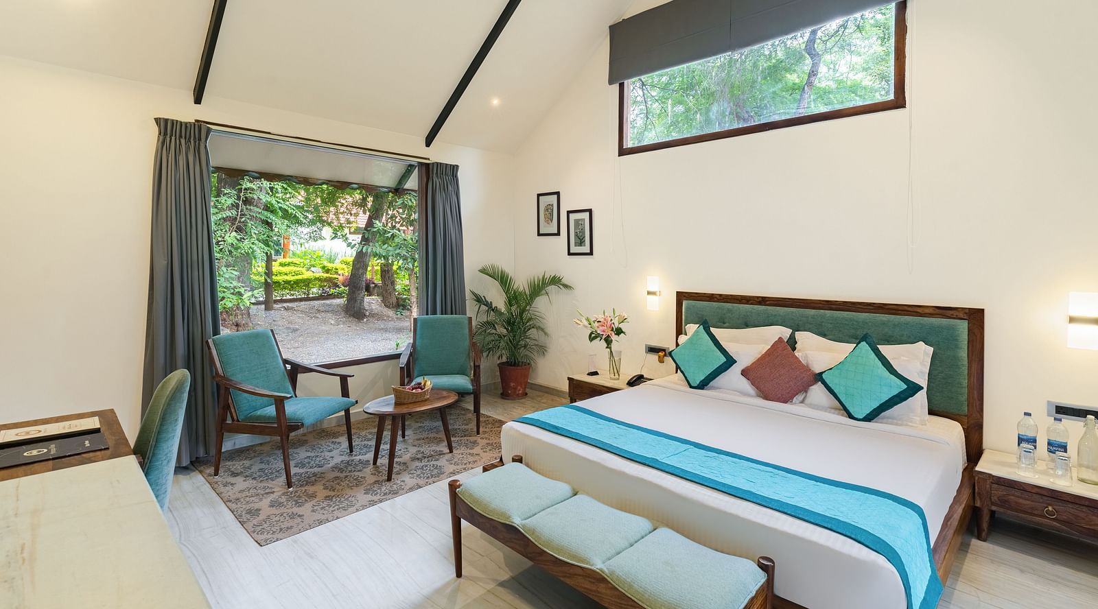 full view of the luxury villa at aranya vilas featuing a king size bed in a brightly lit room with ample natural light falling in the room
