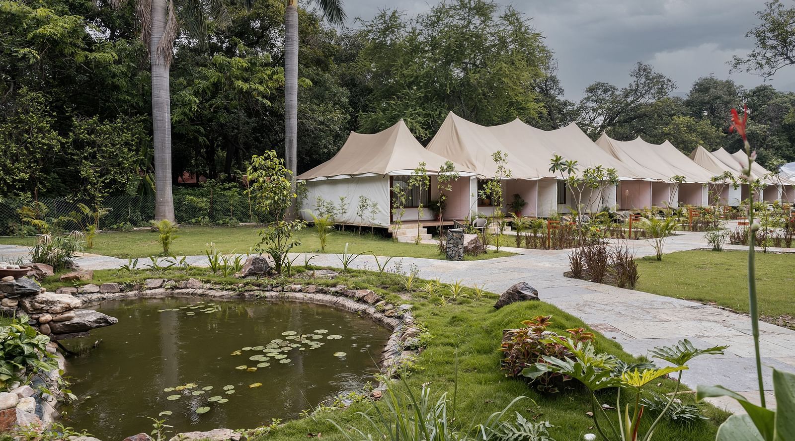 exterior image of the luxury tent villas nestled amidst serene greenery at aranya vilas