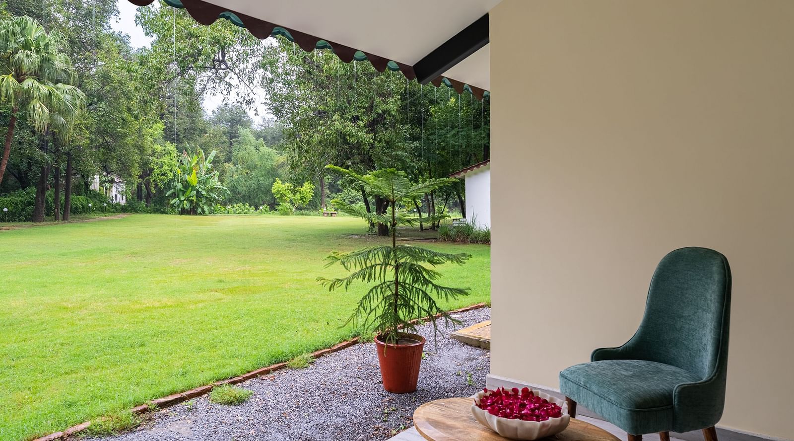 corner view of the sit out area in the luxury family suite opening to a beautiful green lawn