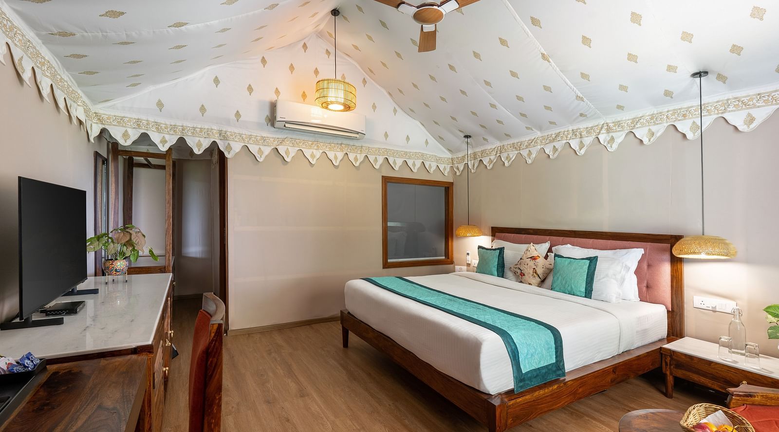 image of a plush king size bed featured in the luxury tent villa at the aranya vilas in udaipur