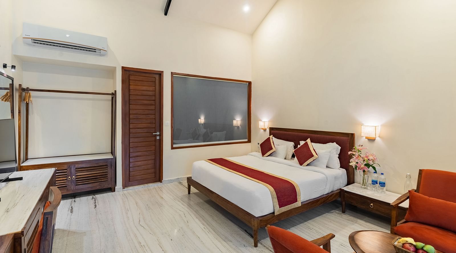 full view image of the luxury bathtub villa featuring a comfortable king size bed under a high pitched ceiling at aranya vilas