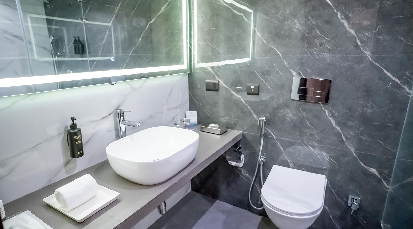 Bathroom with a toilet, sink, and a mirror at ASTER GRAND BY ZENQ SAKET.