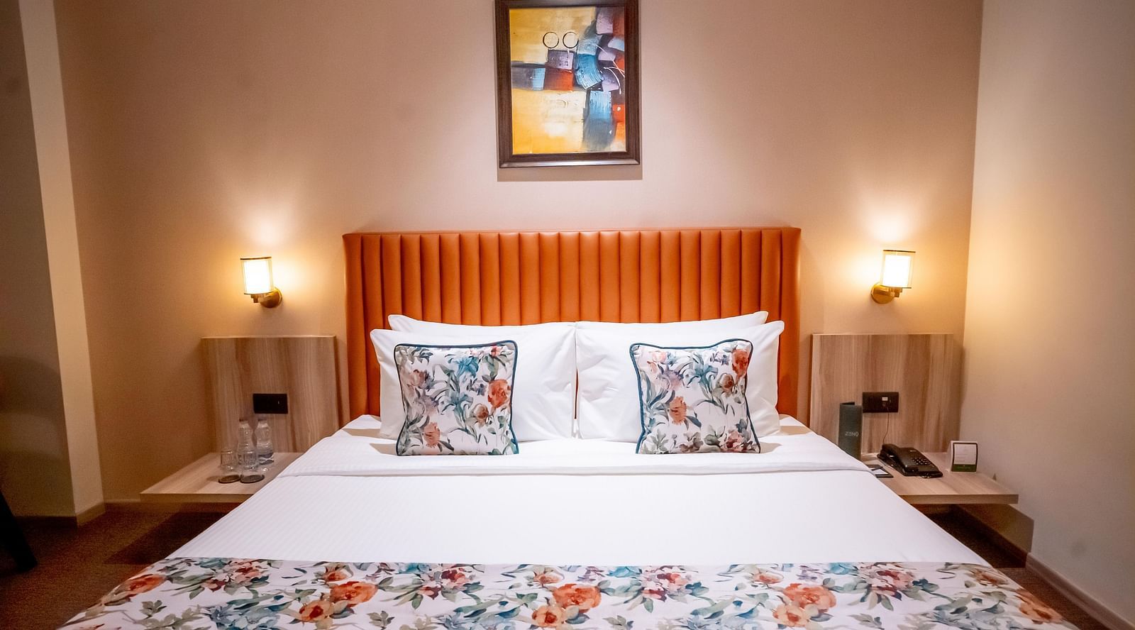 Superior Room at ASTER GRAND BY ZENQ SAKET with a bed, bed side table and a portrait hanging on wall in the background.