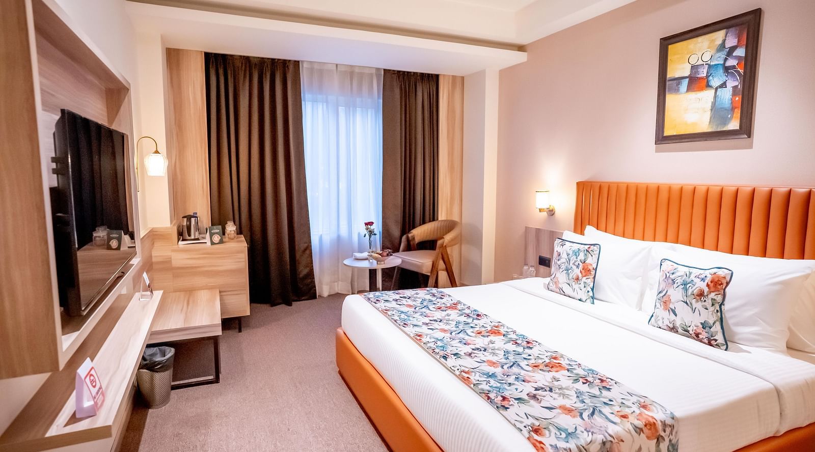 Superior Room at ASTER GRAND BY ZENQ SAKET with a bed, bed side table, TV, a chair and a window with curtain in the background.