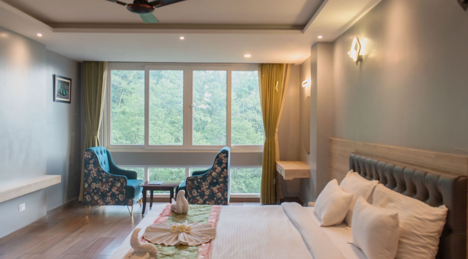 Premuim room with bed, ceiling fan and sewating area at  Avianna Ganagtok Resort and Spa