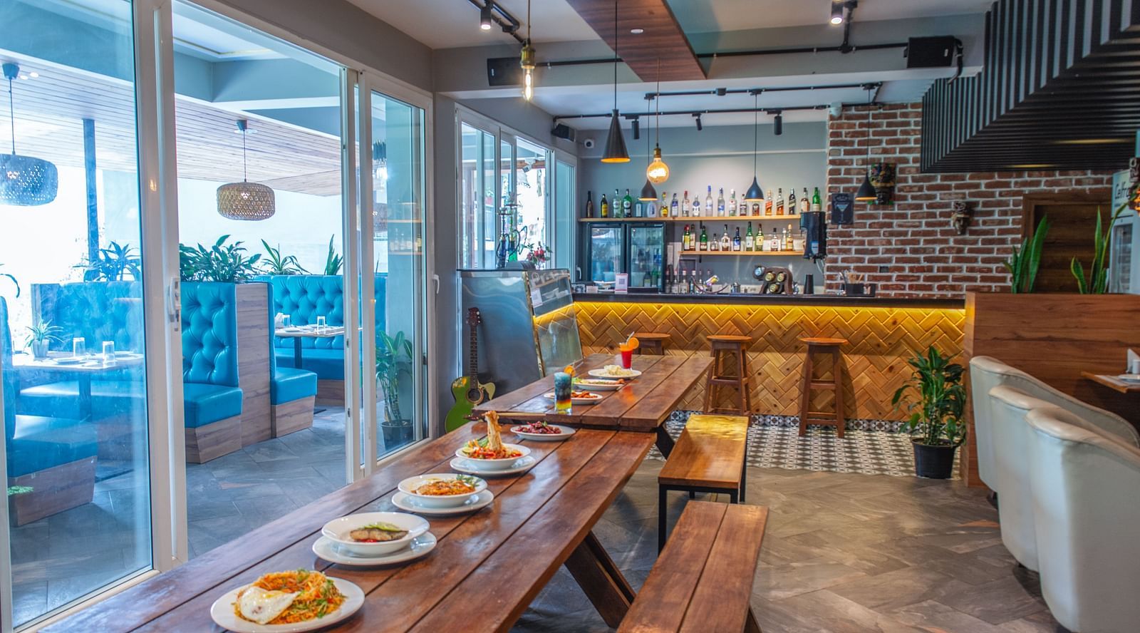 Image of a dining space space with a variety of food on a wooden table at  Avianna Ganagtok Resort and Spa
