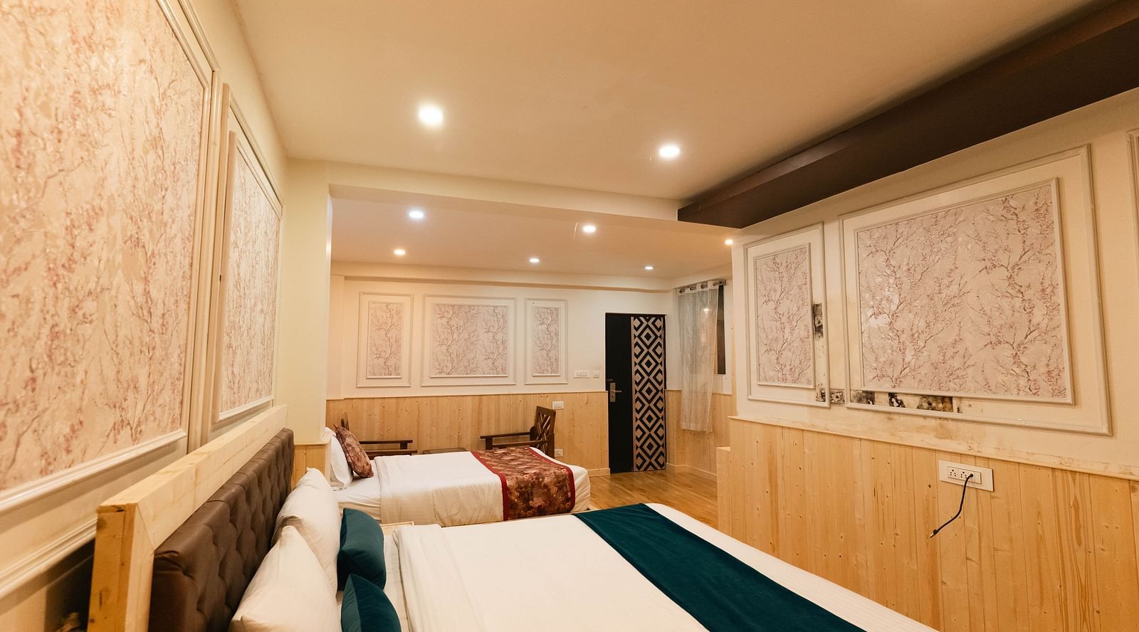 an image of a side view of a family room with two beds at Avianna New Mandala Hotel & Spa, Darjeeling.