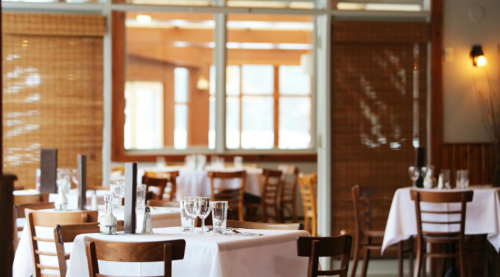 A dining area with comfortable seating, culinary delights neatly arranged on the table, and a warm, inviting ambiance