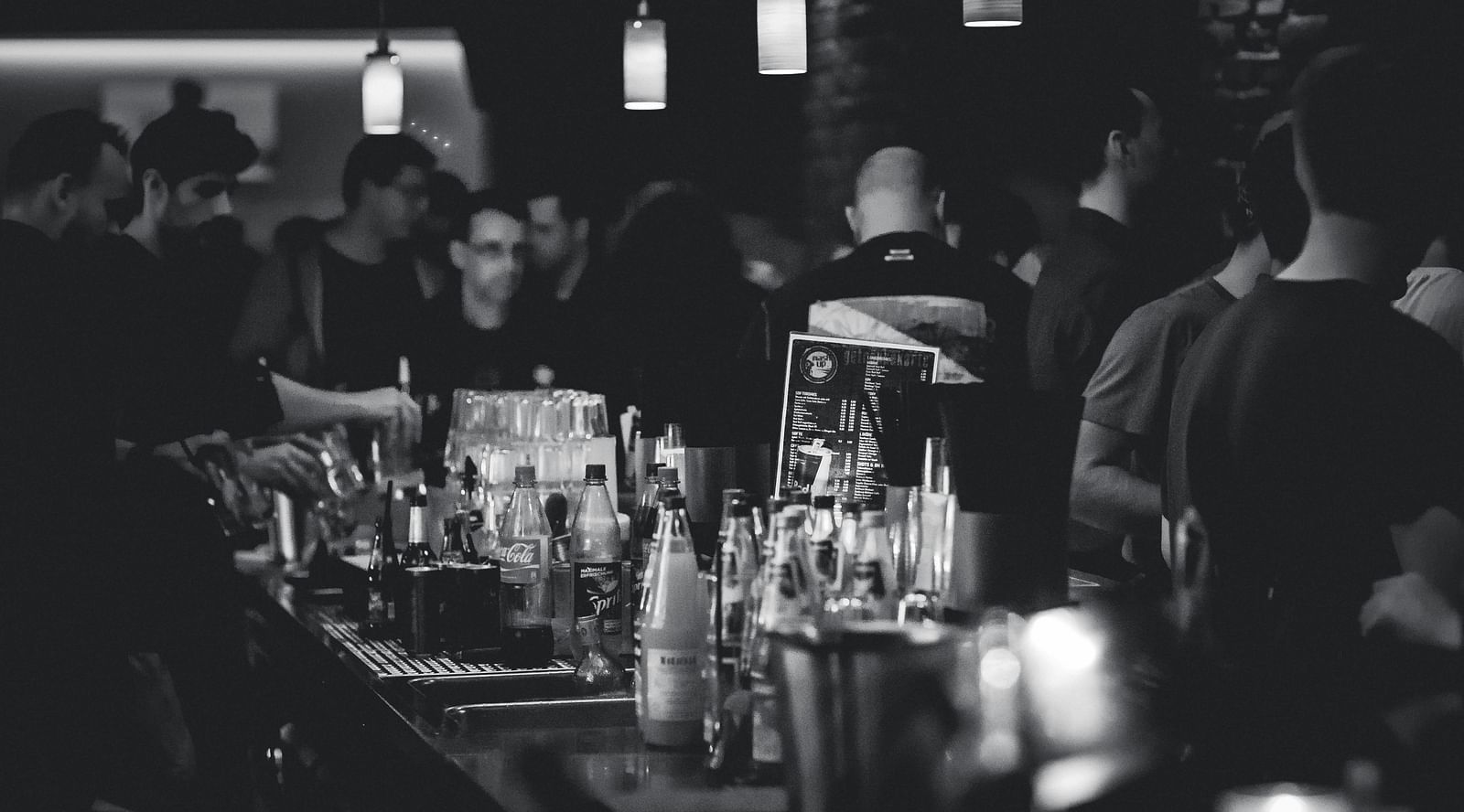 a bar counter with alcohol in bottles