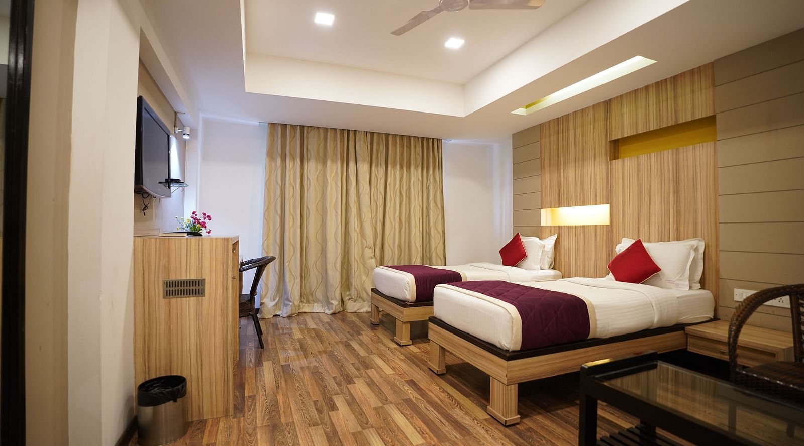 an image of a executive deluxe room with twin beds and a television  