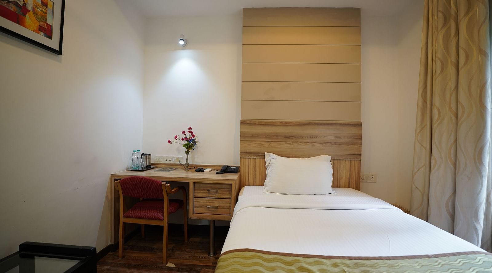 an image of a standard room with a portrait hanging on the wall at  City Centre Residency, Bangalore