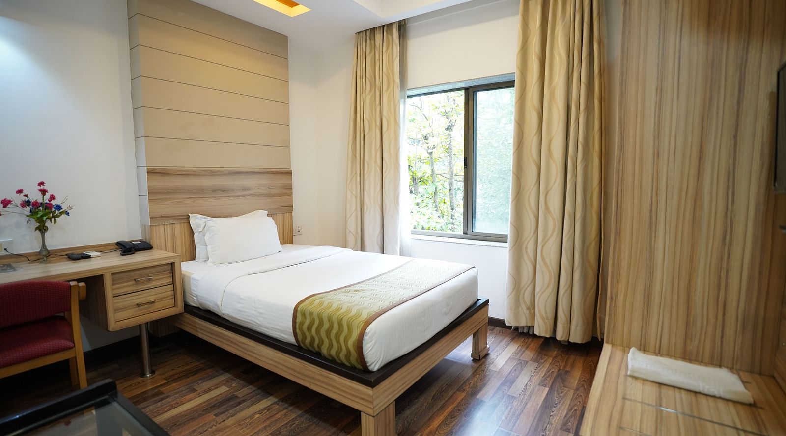 an image of a standard room with a single bed and a window at  City Centre Residency, Bangalore