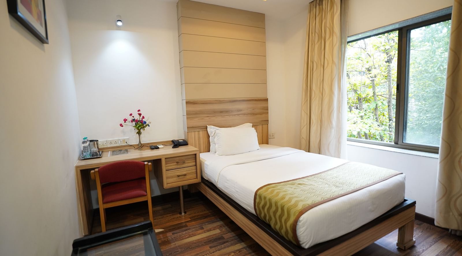an image of a standard room with a working table and a chair at  City Centre Residency, Bangalore