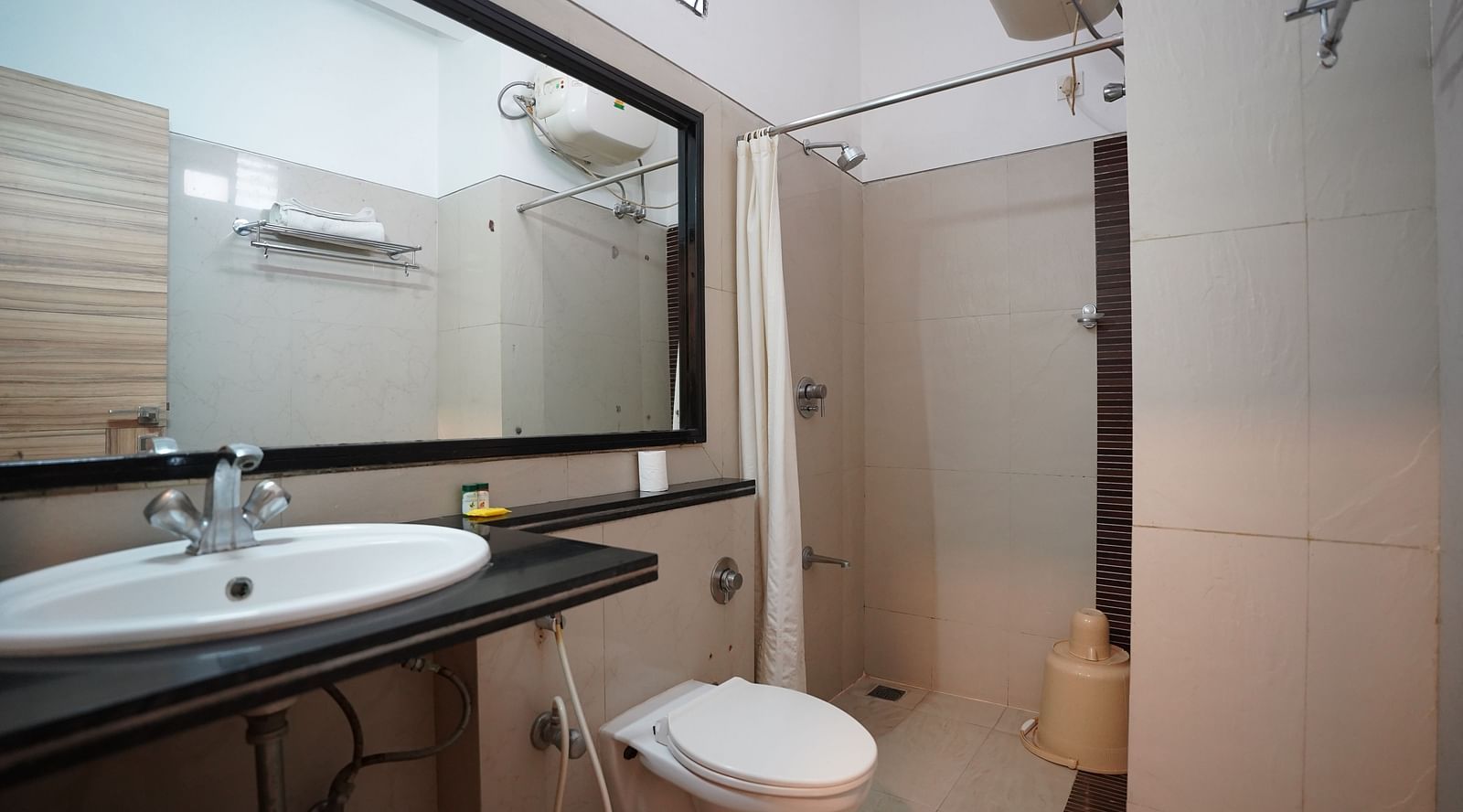 an image of  a bathroom in executive deluxe room with a water heater