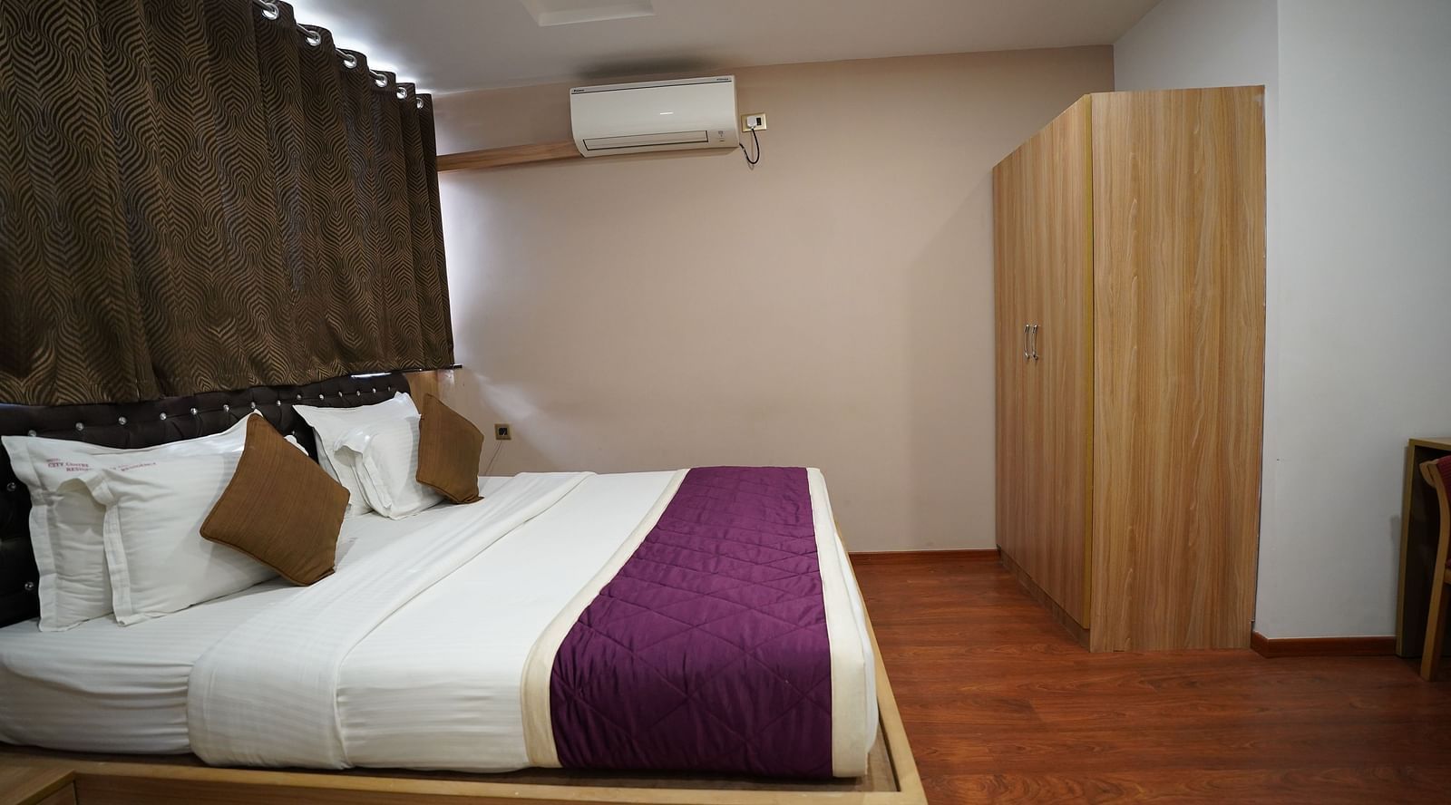 an image of side view of deluxe room with a wardrobe